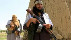 Taliban walk as they celebrate ceasefire in Ghanikhel district of Nangarhar province, Afghanistan June 16, 2018