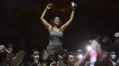 ट्यूनीशिया में प्रधानमंत्री को बर्खास्त किए जाने के बाद खुशी मनाते लोग