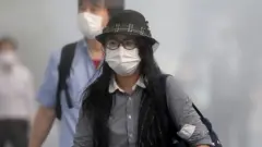 A Japanese woman wears a mask in Tokyo