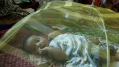 An Indian Christian child lies under a mosquito net at a relief camp in Bhubaneswar, on October 19, 2008 set up for families fleeing the communal violence in Kandhamal district. At the root of the unrest in the Kandhmal district of the Indian state of Orrissa are accusations by hardline Hindus that missionaries lure tribespeople and low-caste Hindus to convert to Christianity by offering free education and health care. AFP PHOTO/Deshakalyan CHOWDHURY (Photo credit should read DESHAKALYAN CHOWDHURY/AFP via Getty Images)