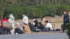 Foxconn employees wait to go home