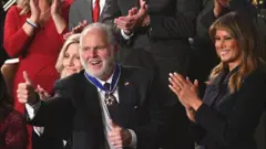 Rush Limbaugh gives a thumbs up after he is awarded the US Presidential Medal of Freedom
