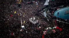 Coffins containing bodies of Qasem Soleimani, Iraqi-Iranian deputy chief of the Popular Mobilization Forces (Hashd Shaabi) commander Jamal Ja'far Muhammad Ali Al Ibrahim, known by the kunya Abu Mahdi al-Muhandis and four other members of the Revolutionary Guard Corps carried by truck during a mass funeral in central Tehran, January 6, 2020. They were killed during an American airstrike in Baghdad airport on Friday January 3rd.