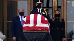 US President Donald Trump and Melania Trump behind Ruth Bader Ginsburg's casket