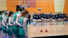 Ireland players stand for their anthem beside the team's bench before playing Israel