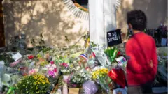 Flowers at a vigil for Mr Paty in Paris, France