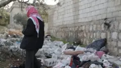 A person inspects the area where the raid happened