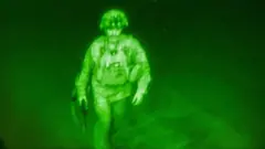 U.S. Army Major General Chris Donahue, commander of the 82nd Airborne Division, steps on board a C-17 transport plane