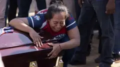 Mujer en funeral de su hijo