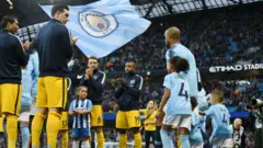 Manchester City players walk out to a guard of honour