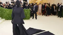 Kim Kardashian dressed in an all-enveloping black outfit that also covers her face