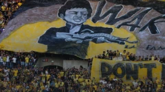 Beitar Jerusalem fans hold banner depicting violent action