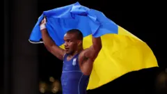 Ukrainian wrestler Zhan Beleniuk celebrates winning gold at the 2020 Olympics in Tokyo