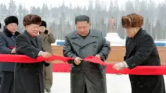 North Korean leader Kim Jong Un cuts the ribbon during a ceremony at the township of Samjiyon County