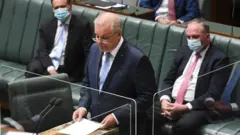 Scott Morrison reads the apology in parliament