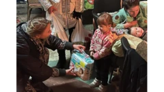 Elena Faizulina delivering diapers in a shelter in Lysychansk