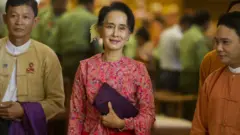 Myanmar"s National League for Democracy (NLD) chairperson Aung San Suu Kyi (C) leaving after the new lower house parliamentary session in Naypyidaw