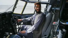 Taliban fighter in US aircraft at Kabul Airport