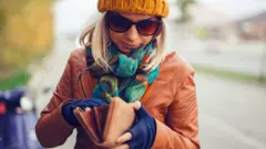 Woman looking in wallet