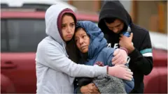 Family members mourn together