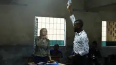 Elecam official dey count votes during di Cameroon 2020 elections