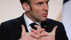 French President Emmanuel Macron gestures as he gives a speech