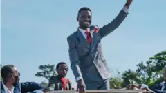 Bobi Wine raising his fist