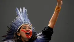An indigenous woman from Amazon reacts during COP25 UN Climate Change Conference