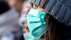 A woman wearing a face mask in London on 1 Feb.