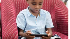 One pikin dey hold phone