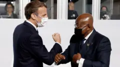 France President Emmanuel Macro dey arm greeting wit Ghana President Nana Akufo-Addo