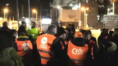Unionists gather as they take part of a strike vote at the Exxon-Mobil Port Jerome Gravenchon refinery, in Port-Jerome-sur-Seine, near Le Havre, northwestern France, on March 7, 2023, on t