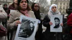 Activists hold portraits of detained or missing Syrians at a demonstration in Paris, France, organised by "Families for Freedom" (27 January 2018)
