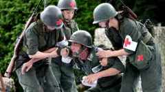 South Korean performers dressed as soldiers participate in a re-enactment