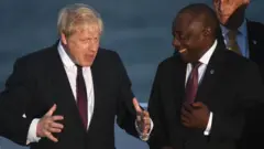 British Prime Minister Boris Johnson and South Africa's President Cyril Ramaphosa join G7 leaders and guests as they gather for a family picture in front of the Biarritz lighthouse on the second day of the annual G7 summit on August 25, 2019
