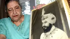 Amrit Kaur, the daughter of the late Maharaja of Faridkot- Harinder Singh Brar, poses with a portrait of the Maharaja at her residence in Chandigarh on August 2, 2013