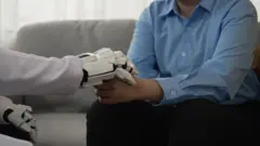 Robô tocando uma mão humana