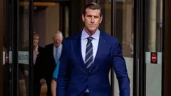 Roberts-Smith walks out of the Federal Court in Sydney in May 2025. In the background are his parents.