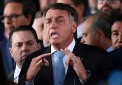 Bolsonaro gesticulando enquanto fala, rodeado por outros homens