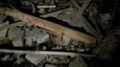 Rubble of wood pieces and bricks filmed at nighttime