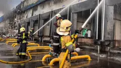 Firefighters work at a site of a Russian drone attack, amid Russia's attack on Ukraine, in the Kyiv region, Ukraine, in this handout picture released August 18, 2026.