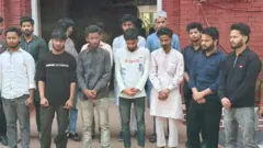पुलिस के साथ खड़े 14 युवक