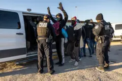 Un oficial de Aduanas y Protección Fronteriza de EE.UU. revisa a inmigrantes antes de transportarlos desde la frontera entre EE. UU. y México el 08 de diciembre de 2023 en Lukeville, Arizona. (Foto de John Moore/Getty Images)