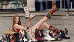 A young model poses with an array of Hawkins boots