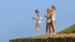 Foreign tourists visit Galle Fort in Galle, Sri Lanka, on July 11, 2025. First constructed by the Portuguese in 1588 and later extensively fortified by the Dutch from 1649 onwards, the fort is now a UNESCO World Heritage Site preserved by the Department of Archaeology. It remains one of the country's most prominent cultural and historical attractions.