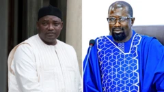 Barrow in white wearing black cap, Ceesay 