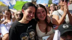 兩名在特拉維夫人質廣場觀看哈馬斯釋放以色列人質的女孩喜極而泣