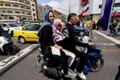 Tres personas a bordo de una moto en Teherán