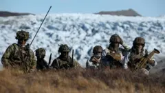 Danish troops practice looking for potential threats during a military drill in Greenland