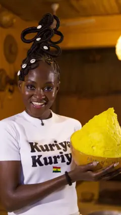 Founder of Shea Butter Museum carry shea butter in a calabash